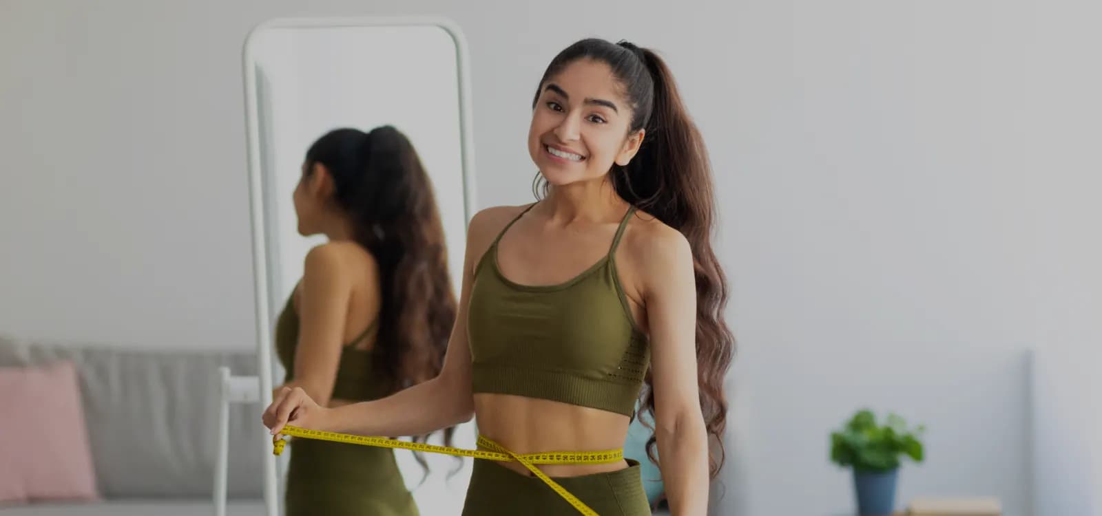Woman checking her progress in a mirror at home